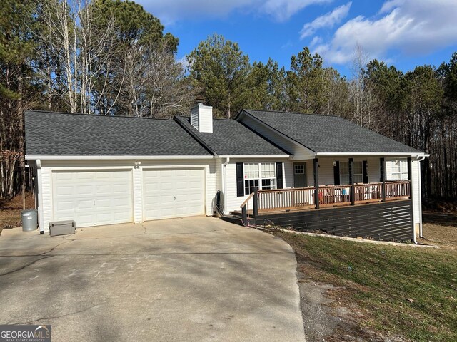 129 Carolyn Path, Rockmart, GA 30153 - ranch-style house featuring a garage, concrete driveway, a chimney, a porch, and a shingled roof