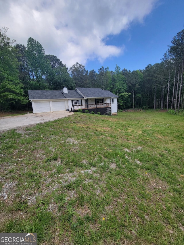129 Carolyn Path, Rockmart, GA 30153 - view of front of property featuring driveway, an attached garage, a front yard, and a wooded view