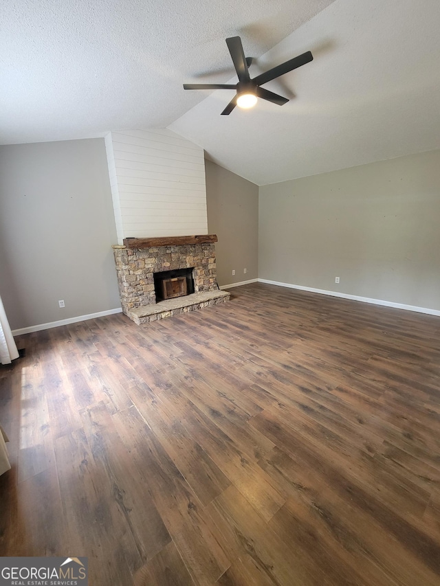 129 Carolyn Path, Rockmart, GA 30153 - unfurnished living room with ceiling fan, dark wood-type flooring, vaulted ceiling, baseboards, and a fireplace