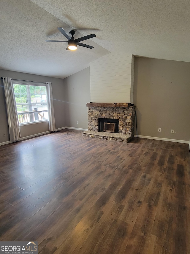129 Carolyn Path, Rockmart, GA 30153 - unfurnished living room featuring a textured ceiling, a ceiling fan, lofted ceiling, dark wood-style floors, and a fireplace