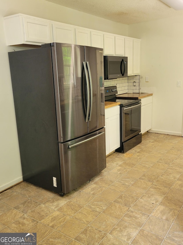 129 Carolyn Path, Rockmart, GA 30153 - kitchen with appliances with stainless steel finishes, decorative backsplash, white cabinets, baseboards, and light countertops