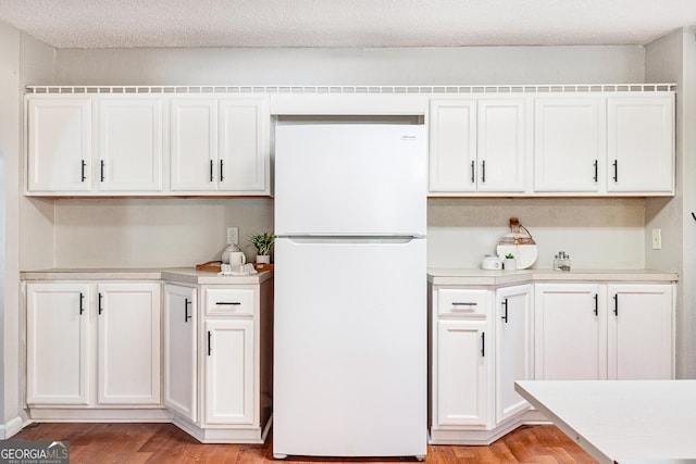709 Tallapoosa Hwy, Cedartown, GA 30125 - kitchen featuring light countertops, freestanding refrigerator, light wood-style flooring, and white cabinetry