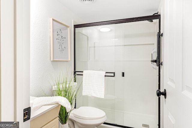 709 Tallapoosa Hwy, Cedartown, GA 30125 - full bathroom with visible vents, a textured wall, a stall shower, and toilet