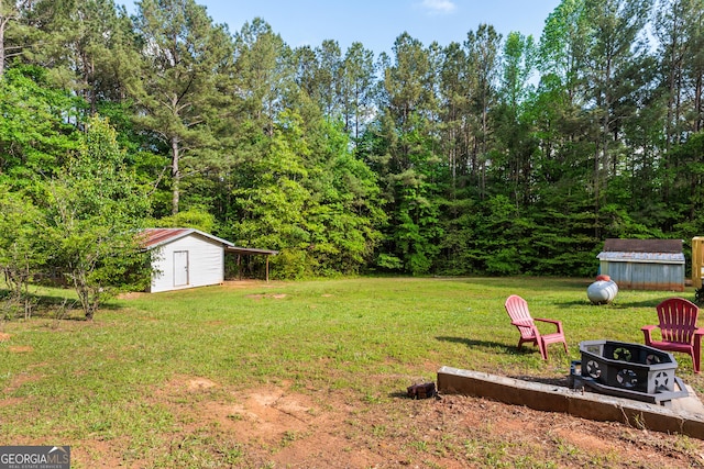 709 Tallapoosa Hwy, Cedartown, GA 30125 - view of yard with an outbuilding, a shed, and an outdoor fire pit