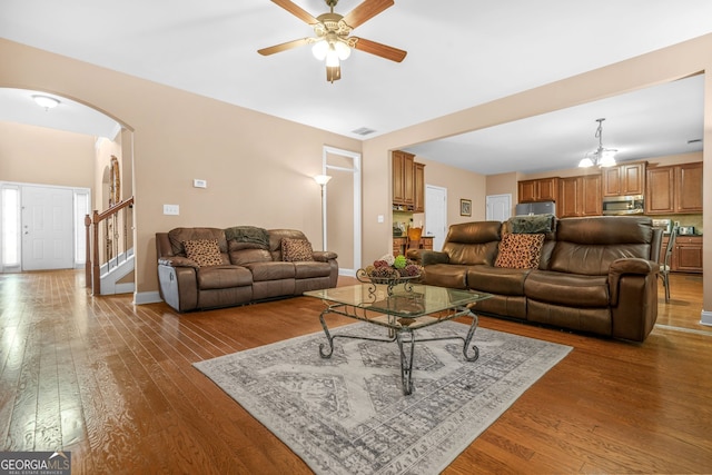4616 Town Manor Dr, Douglasville, GA 30135 - living room featuring wood-type flooring, arched walkways, ceiling fan, and visible vents