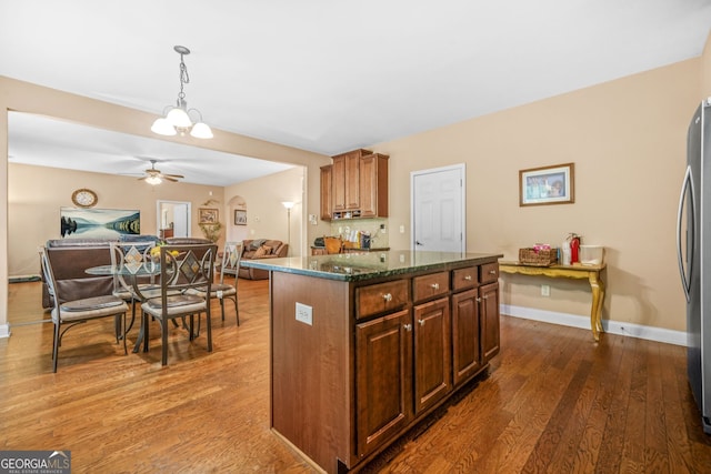 4616 Town Manor Dr, Douglasville, GA 30135 - kitchen featuring pendant lighting, wood finished floors, open floor plan, a center island, and a ceiling fan