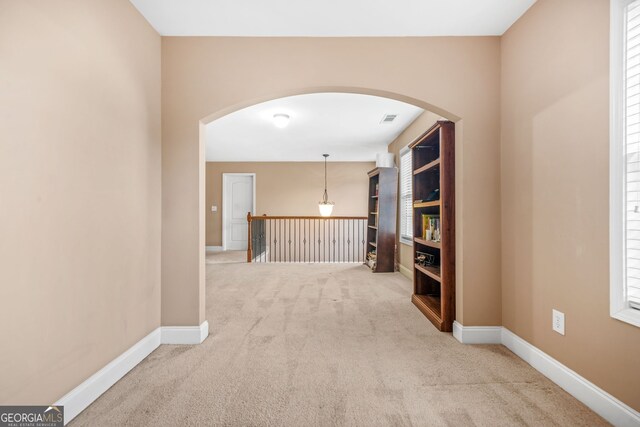 4616 Town Manor Dr, Douglasville, GA 30135 - hallway featuring carpet floors, arched walkways, baseboards, and visible vents