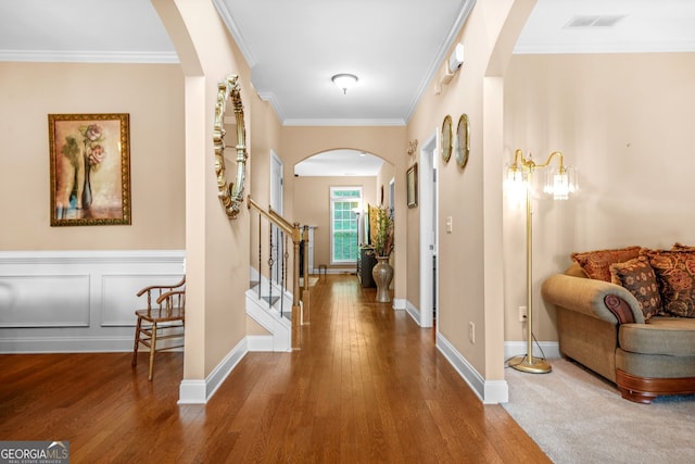 4616 Town Manor Dr, Douglasville, GA 30135 - hall featuring visible vents, arched walkways, wood-type flooring, ornamental molding, and stairs