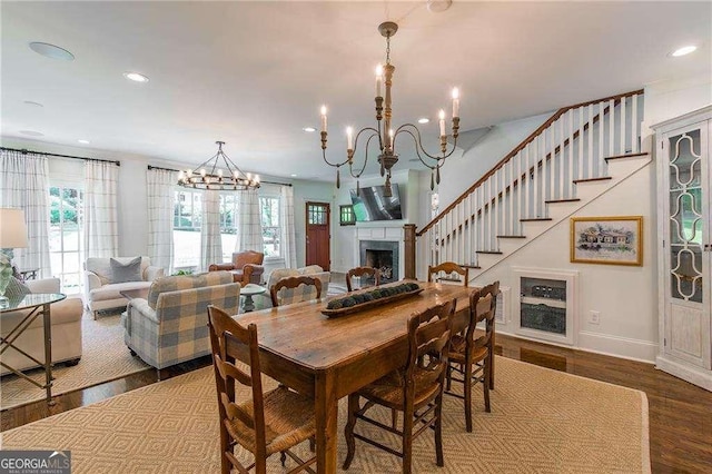 dining room featuring an inviting chandelier, recessed lighting, baseboards, and wood finished floors