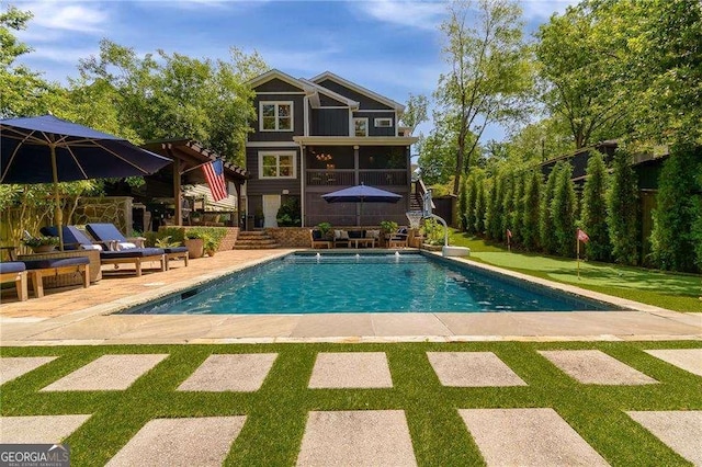 pool featuring stairs, a yard, a patio area, and fence private yard