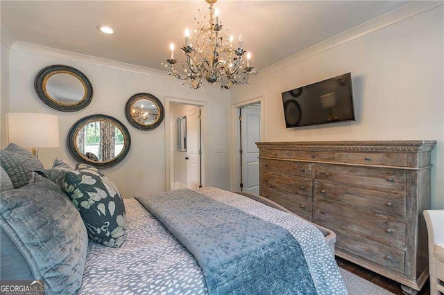 bedroom with a notable chandelier, ornamental molding, and wood finished floors