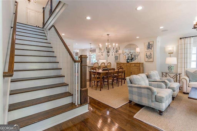 living area with an inviting chandelier, recessed lighting, stairway, and dark wood-style floors