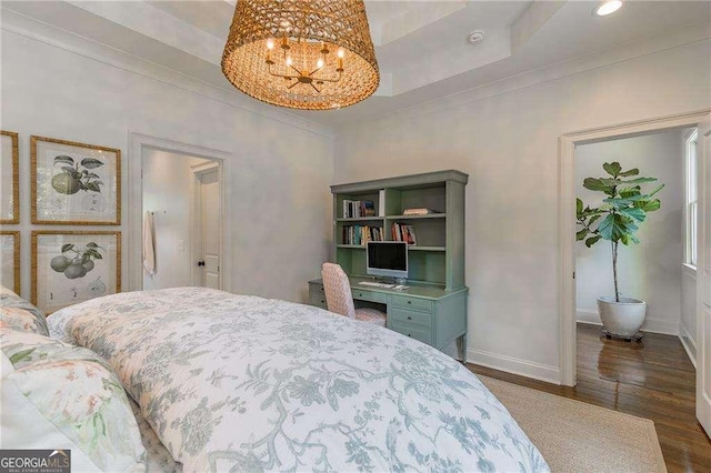bedroom featuring baseboards, a chandelier, ornamental molding, and wood finished floors