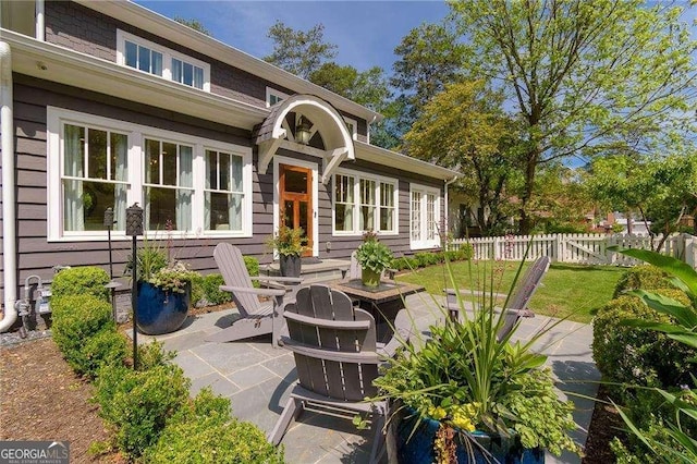 view of patio / terrace featuring fence and french doors