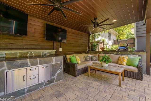 view of patio / terrace with exterior kitchen, outdoor lounge area, and a ceiling fan