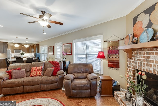 55 Sudderth St, Buford, GA 30518 - living area featuring a ceiling fan, a fireplace, light wood-type flooring, baseboards, and ornamental molding