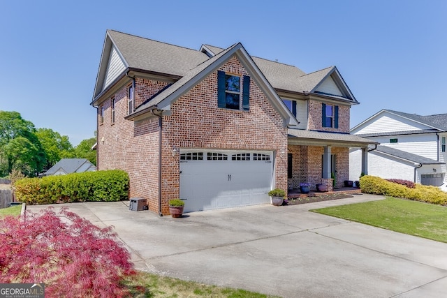 55 Sudderth St, Buford, GA 30518 - view of front facade featuring covered porch, brick siding, an attached garage, and driveway