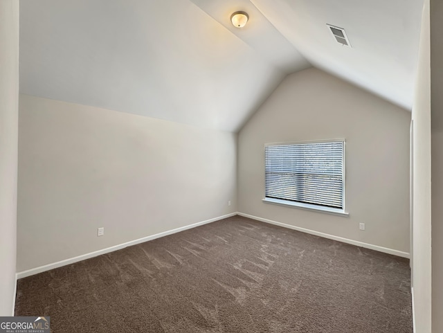 376 Layfield Dr, Jonesboro, GA 30238 - additional living space featuring dark colored carpet, baseboards, vaulted ceiling, and visible vents