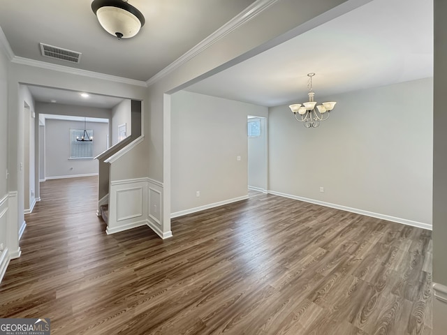376 Layfield Dr, Jonesboro, GA 30238 - empty room with visible vents, ornamental molding, baseboards, dark wood-type flooring, and a notable chandelier