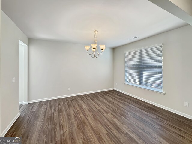 376 Layfield Dr, Jonesboro, GA 30238 - spare room featuring baseboards, dark wood-style flooring, a notable chandelier, and visible vents