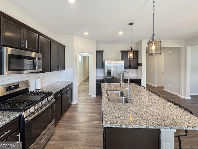376 Layfield Dr, Jonesboro, GA 30238 - kitchen featuring a sink, baseboards, a breakfast bar area, and stainless steel appliances