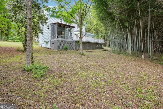 3688 Burnley Ct, Lithonia, GA 30038 - view of yard featuring a sunroom and a wooden deck