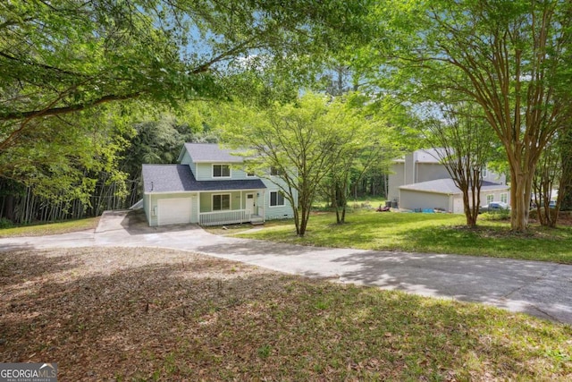 3688 Burnley Ct, Lithonia, GA 30038 - view of front of house with a porch, an attached garage, driveway, and a front lawn