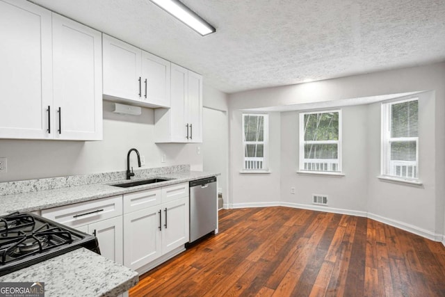 3688 Burnley Ct, Lithonia, GA 30038 - kitchen featuring dark wood-style flooring, visible vents, stainless steel dishwasher, a sink, and white cabinets
