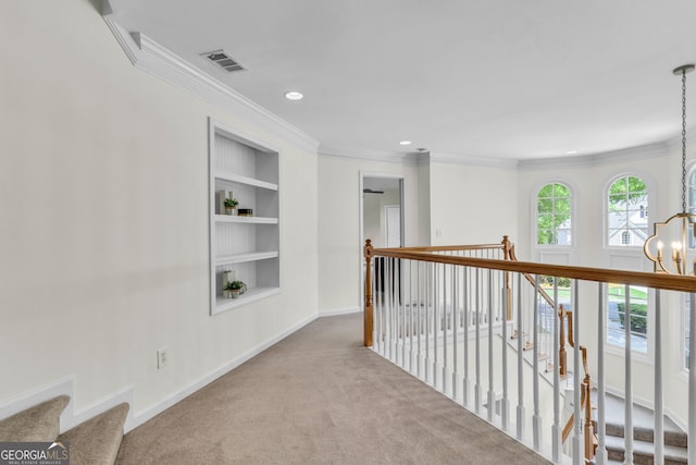 5303 Davenport Mnr, Cumming, GA 30041 - corridor with built in shelves, baseboards, a notable chandelier, ornamental molding, and carpet