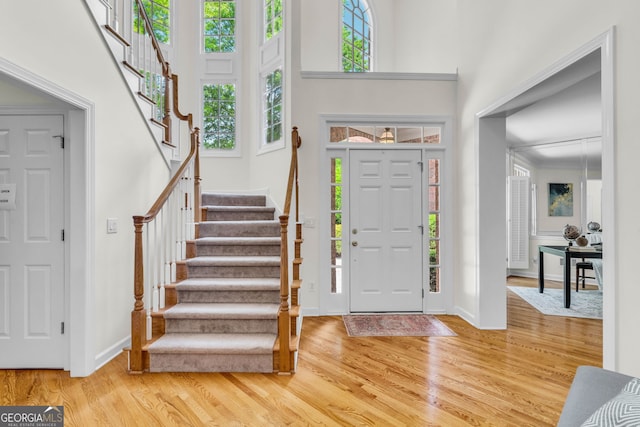 5303 Davenport Mnr, Cumming, GA 30041 - entryway with stairway, baseboards, wood finished floors, and a towering ceiling