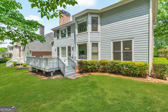 5303 Davenport Mnr, Cumming, GA 30041 - rear view of house featuring a lawn, a wooden deck, and a chimney