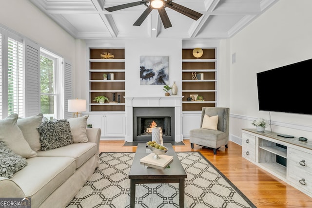 5303 Davenport Mnr, Cumming, GA 30041 - living room featuring a ceiling fan, a fireplace with flush hearth, built in features, and coffered ceiling