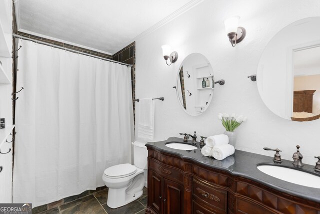 bathroom with double vanity, toilet, a shower with shower curtain, and ornamental molding