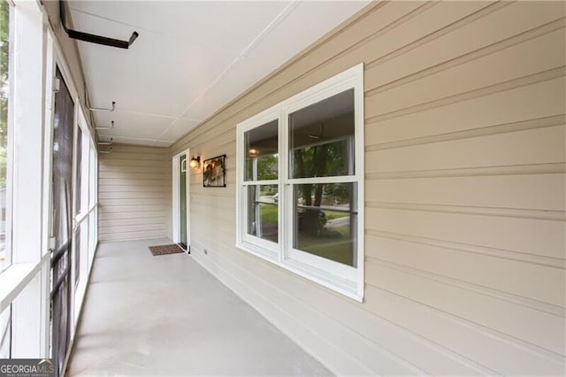 848 E Ave, Scottdale, GA 30079 - unfurnished sunroom with wooden walls and finished concrete flooring