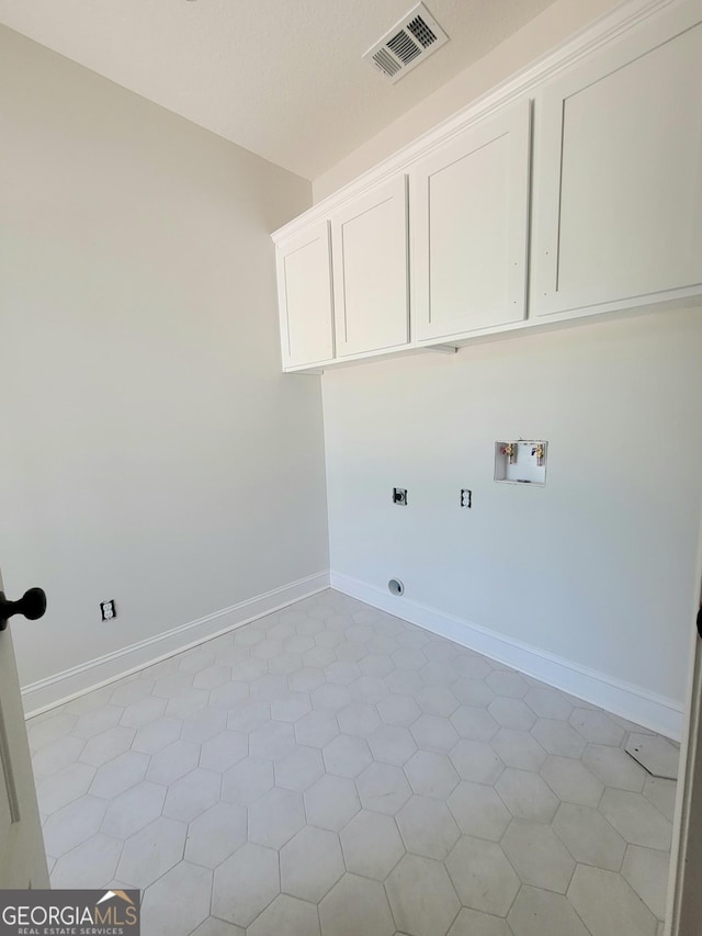 laundry room with visible vents, baseboards, hookup for a washing machine, electric dryer hookup, and cabinet space