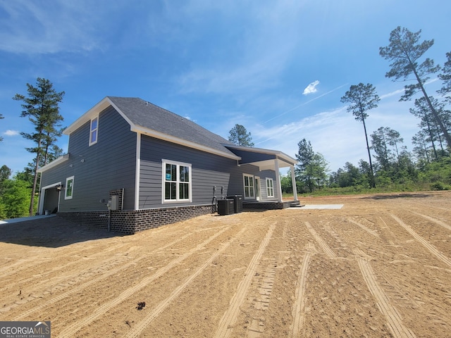 back of house featuring central air condition unit