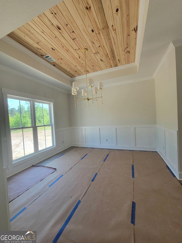 unfurnished room featuring crown molding, a decorative wall, and wooden ceiling