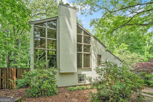 1213 Laurel Cliff Dr SE, Smyrna, GA 30082 - view of side of property featuring fence and a chimney