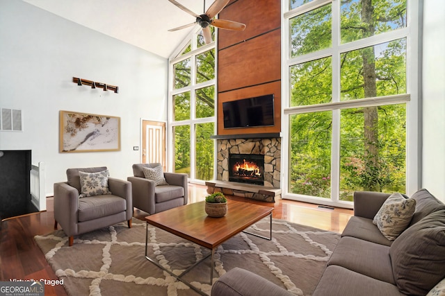 1213 Laurel Cliff Dr SE, Smyrna, GA 30082 - unfurnished living room featuring visible vents, a fireplace, baseboards, hardwood / wood-style flooring, and a ceiling fan