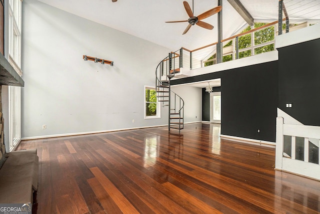 1213 Laurel Cliff Dr SE, Smyrna, GA 30082 - unfurnished living room with ceiling fan, beam ceiling, high vaulted ceiling, stairs, and hardwood / wood-style floors