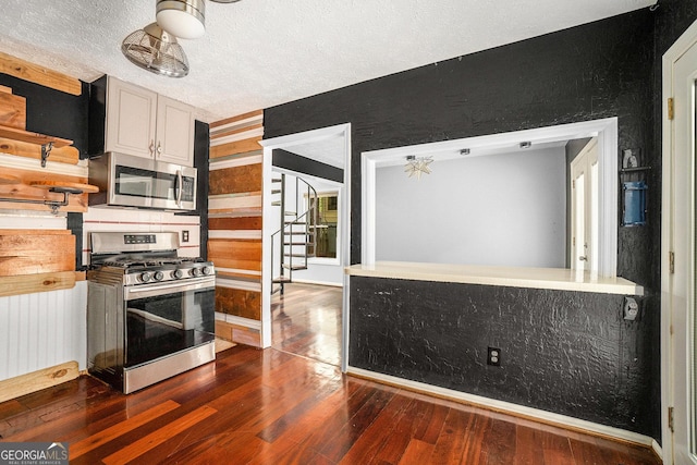1213 Laurel Cliff Dr SE, Smyrna, GA 30082 - kitchen featuring open shelves, a textured ceiling, dark wood finished floors, and appliances with stainless steel finishes
