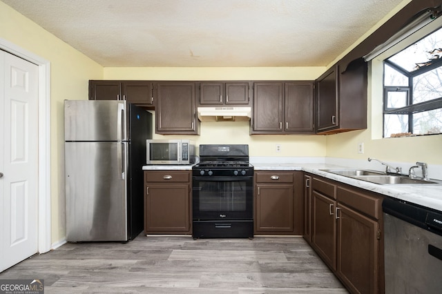 4157 Lake Mist Dr NW, Kennesaw, GA 30144 - kitchen with a sink, appliances with stainless steel finishes, under cabinet range hood, and light countertops