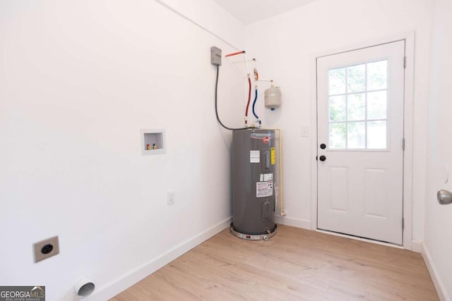 laundry area with laundry area, light wood finished floors, hookup for a washing machine, water heater, and electric dryer hookup