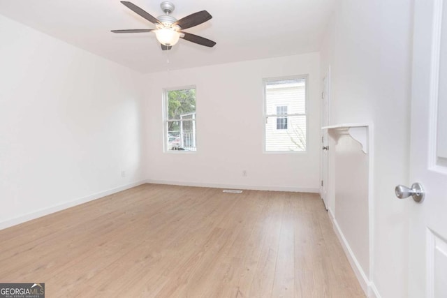 unfurnished room with light wood-style floors, baseboards, and ceiling fan