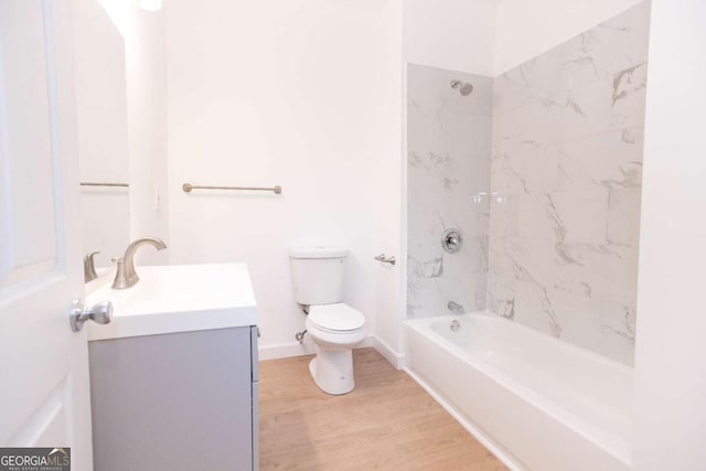 full bathroom featuring toilet,  shower combination, wood finished floors, and vanity