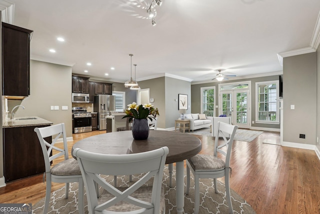 737 St Charles Ave NE, Atlanta, GA 30306 - dining room with baseboards, light wood-style floors, ornamental molding, french doors, and a ceiling fan