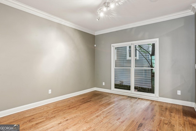737 St Charles Ave NE, Atlanta, GA 30306 - spare room featuring baseboards, wood finished floors, and crown molding