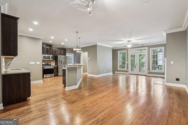 737 St Charles Ave NE, Atlanta, GA 30306 - kitchen featuring appliances with stainless steel finishes, dark brown cabinets, light wood-type flooring, ceiling fan, and baseboards