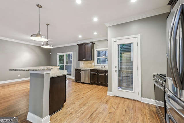 737 St Charles Ave NE, Atlanta, GA 30306 - kitchen featuring appliances with stainless steel finishes, a sink, dark brown cabinetry, ornamental molding, and light wood-type flooring