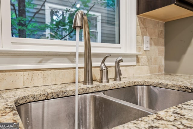 737 St Charles Ave NE, Atlanta, GA 30306 - kitchen view of a sink, decorative backsplash, and light stone counters